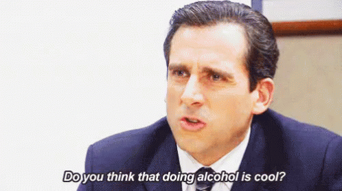 a man in a suit and tie is sitting at a table and saying `` do you think that doing alcohol is cool '' .